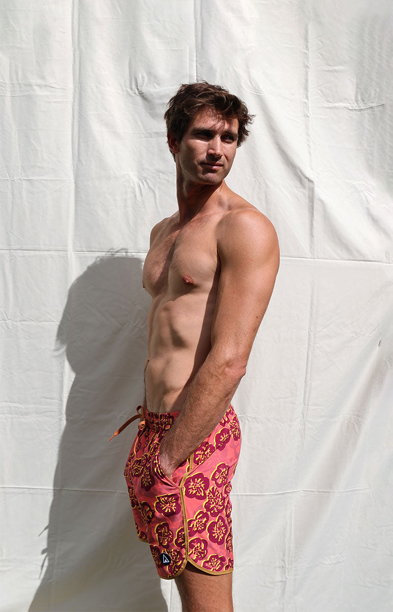 tai swim co braden 7inch trunks in ewa hawaii hibiscus style red floral hawaiian boardshorts designed on oahu in hawaii red vibrant lifeguard style boardshort trunks old school surfer style trunks oahu hawaii matching bikini and boardshorts his and hers swimwear