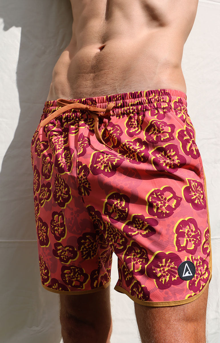 tai swim co braden 7inch trunks in ewa hawaii hibiscus style red floral hawaiian boardshorts designed on oahu in hawaii red vibrant lifeguard style boardshort trunks old school surfer style trunks kailua local swimwear brands