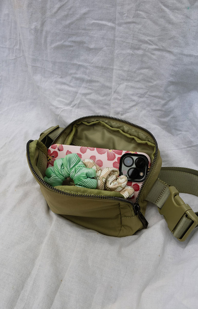A cross body bag made from recycled materials, resembling a 1L size and inspired by Lululemon. The bag features vibrant colors reminiscent of bikinis, making it a stylish and sustainable accessory from hawaii kailua oahu sustainable swimwear accessories