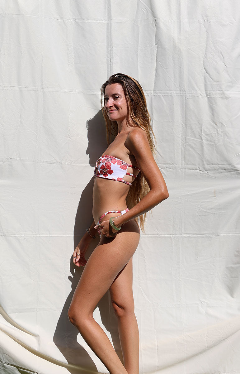tai swim co devin top bandeau strapless bikini top from kailua oahu hawaii with red flowers and iwa bird details from o'ahu's north shore sustainable materials skimpy recycled fabric bikini from kailua oahu