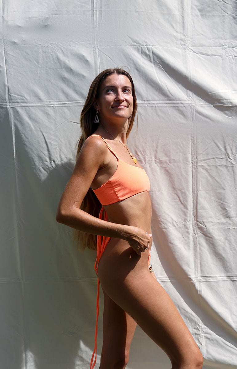 tai swim co orange emily top in clementine ribbed textured scoop neck cross tie back long strings sustainable swimwear on sale from hawaii affordable cute hawaii designs bright comfy size inclusive swimsuits on oahu kailua hawaii thin strap bikini tops and bottoms