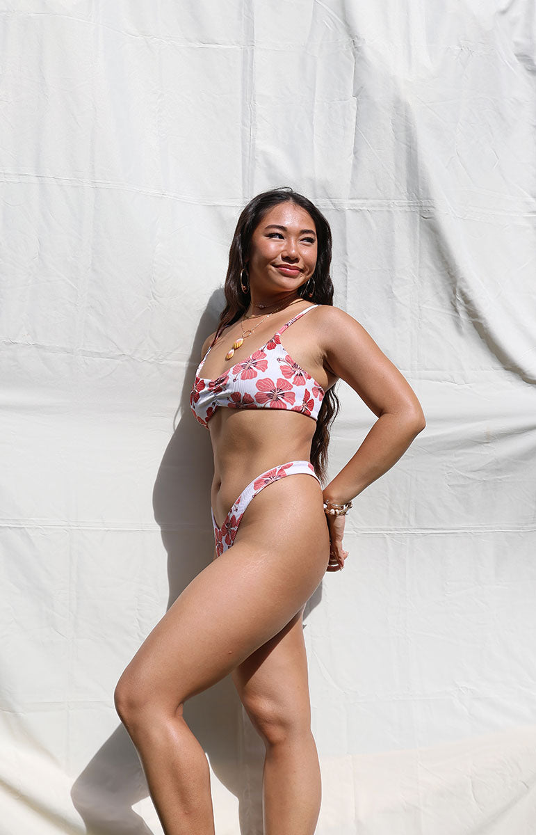 tai swim co emma top in haleiwa floral red hibiscus print from kailua oahu hawaii scrunchy comfy bra top for yoga and surfing and working out active swimwear top made with ribbed material and seamless stitching from kailua oahu hawaii