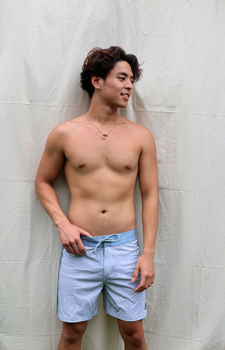 tai swim sustainable men's boardshorts gavin swimwear trunks in tonggs blue floral hibiscus print swimwear boardshorts for guys and girls with tai swim logo patch detail made in hawaii designed in kailua oahu hawaii hidden print sustainable eco friendly boardshorts from windward side oahu matching swimwear and boardshorts eco friendly vissla style surf shorts with drawstring and pocket