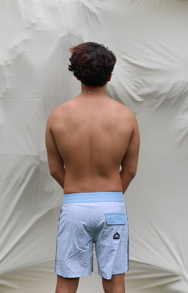 tai swim sustainable men's boardshorts gavin swimwear trunks in tonggs blue floral hibiscus print swimwear boardshorts for guys and girls with tai swim logo patch detail made in hawaii designed in kailua oahu hawaii hidden print sustainable eco friendly boardshorts from windward side oahu matching swimwear and boardshorts eco friendly vissla style surf shorts with drawstring and pocket kahala matching with tai swim bikinis logo patch hawaii style boardies