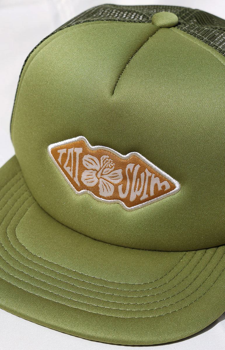 tai swim green hunter green foam trucker beach hat with custom tai swim co hand drawn logo art surf classic vintage hat with hidden print artwork sustainable eco friendly hat logo with flower patch hand drawn