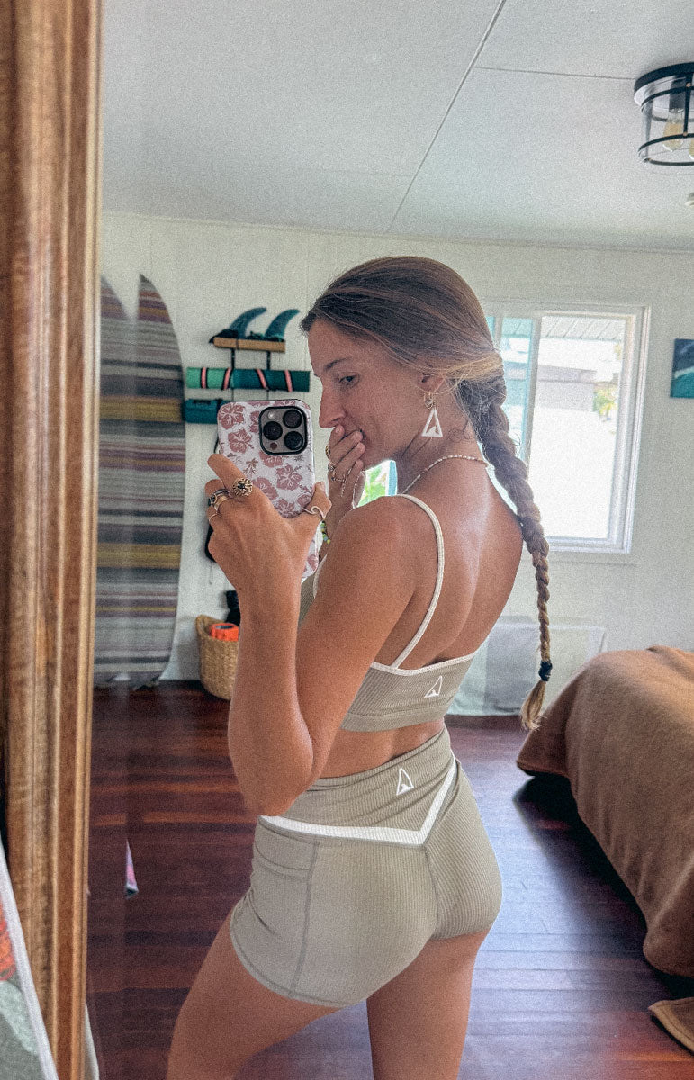 tai swim co kylie top and shorts in chai sustainable eco friendly workout gear from oahu kailua hawaii ribbed light tan materials with triangle wave white logo tai swim co branding kailua oahu hawaii piping two tone ribbed bikini material workout sets tai swim co from oahu hawaii