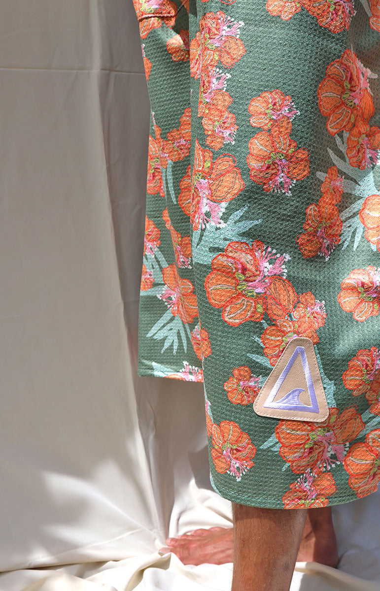 tai swim waikoloa orange and green wiliwili flower changing surf poncho made from recycled waffle terry microfiber hooded towel for tall guys comfy snuggie quick drying towel from oahu hawaii kailua local hawaiian accessories from hawaii comfy textured towels for changing at the beach