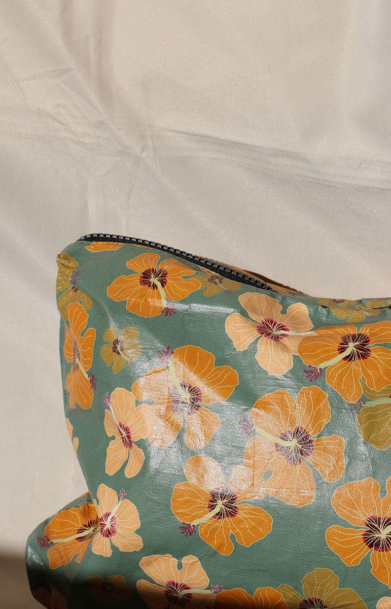 Floral-patterned milo tai swim co pouch on a white background