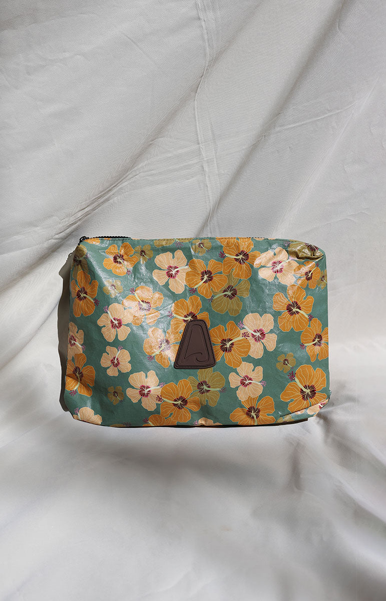 Milo tai swim Floral-patterned bag with a brown handle on a white fabric background