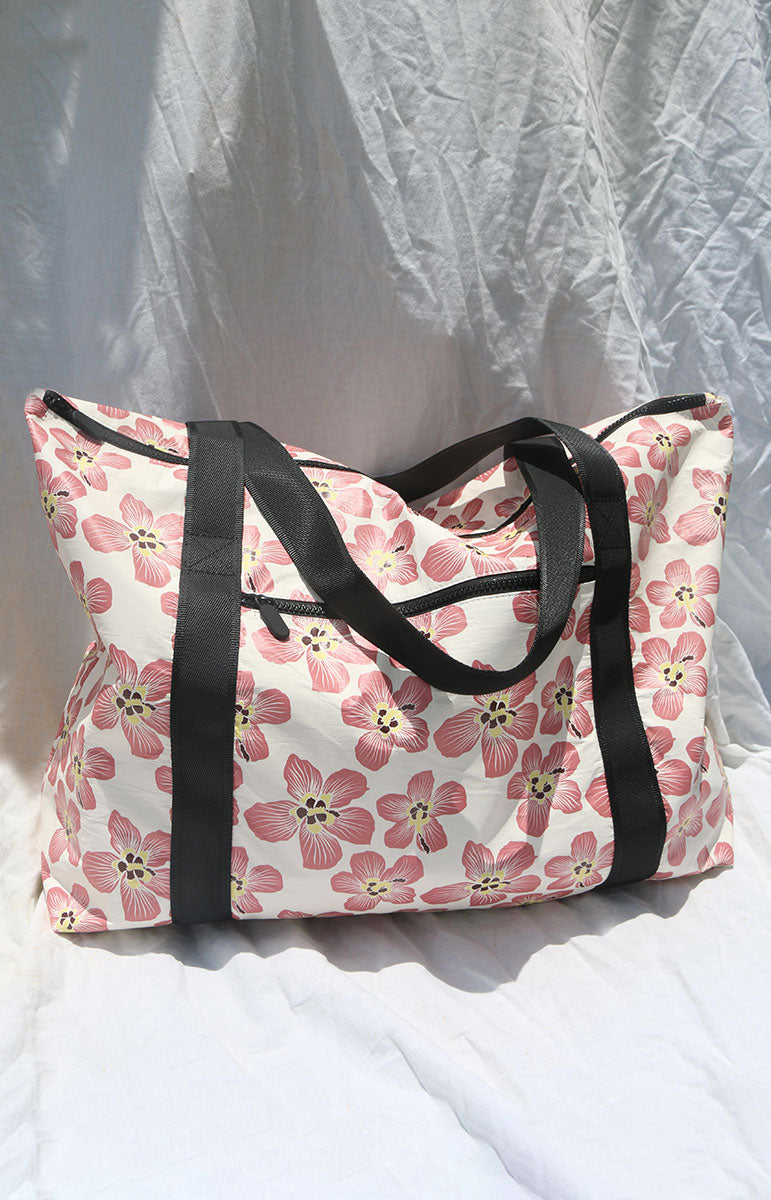 tai swim co recycled tyvek large beach tote with hand drawn floral hau bush flowers in the haena print inspired by kauai north shore florals hawaii sustainable swimwear and splash proof accessories