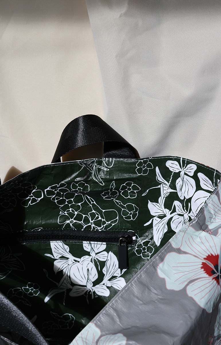 tai swim co kailua hibiscus red from kailua oahu hawaii recycled reversible tyvek bag reverses to dark green puakenikeni print floral bag