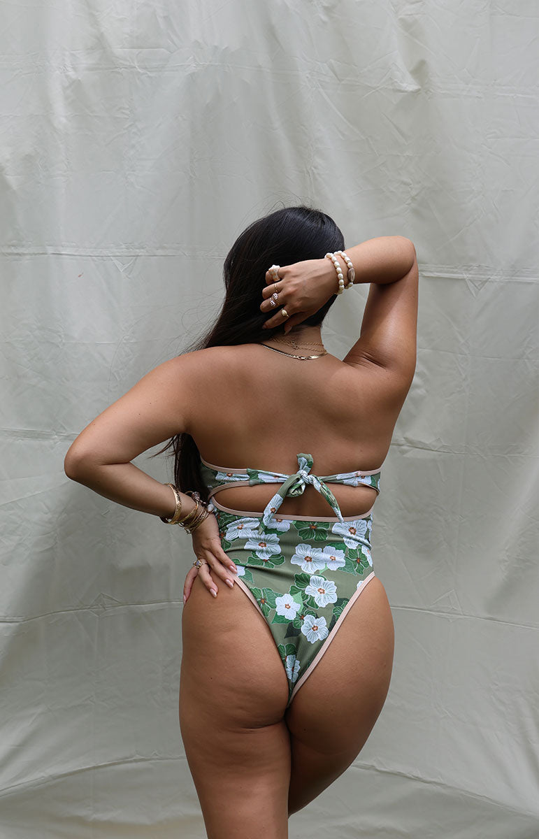 tai swim co sarah one piece from oahu kailua hawaii green and white pikake floral hawaiian swimwear print with retro sporty piping and green leaves with a vintage silhouette and reversible lining with tie in the back
