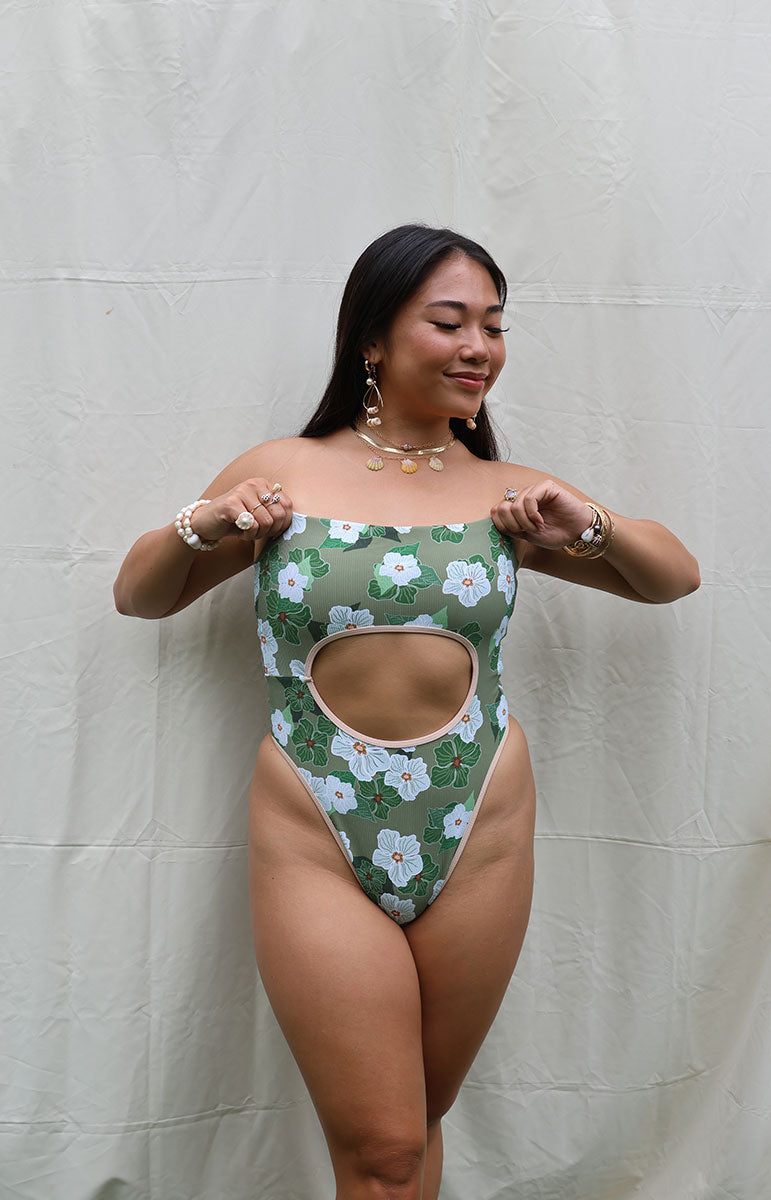 tai swim co sarah one piece from oahu kailua hawaii green and white pikake floral hawaiian swimwear print with retro sporty piping and green leaves with a vintage silhouette and reversible lining with tie in the back sustainable swimwear from hawaii