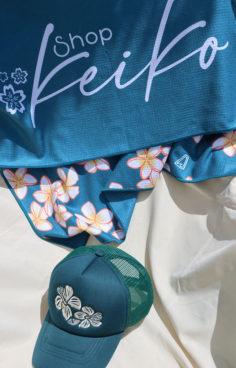 tai swim co shop keiko collaboration towels with blue and pink plumeria tropical hawaii flowers from oahu kailua hawai'i