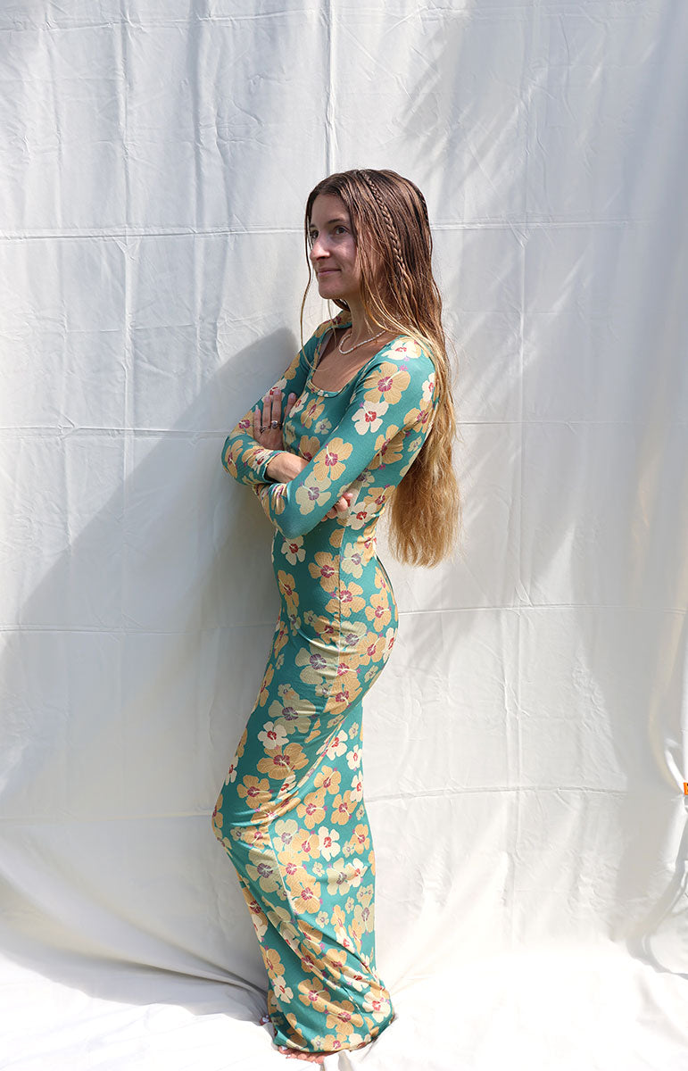 tai swim long sleeve starsea dress in milo green yellow floral hawaii print dress from oahu hawaii small batch sustainable bikini brand and maxi dress comfy clothing from oahu hawaiian islands design flowers matching bikini tops and bottoms model with braids in long sleeve skimpy dress