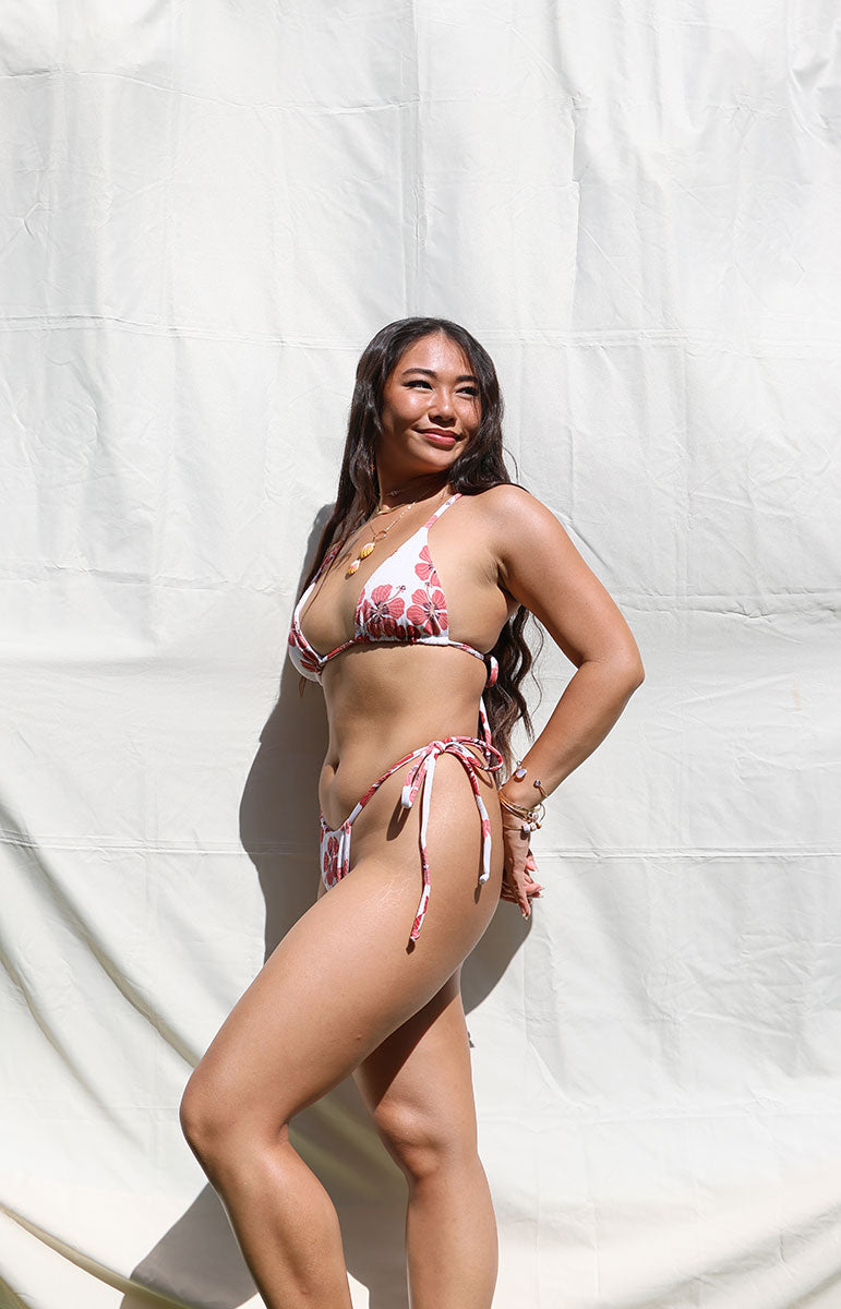 tai swim co tai bottom in haleiwa cheeky designer swimwear from oahu hawaii stringy ribbed textured high quality swimsuits made by hand in hawaii oahu kailua hawaiian owned swimwear side ties on model sunny photoshoot oahu north shore