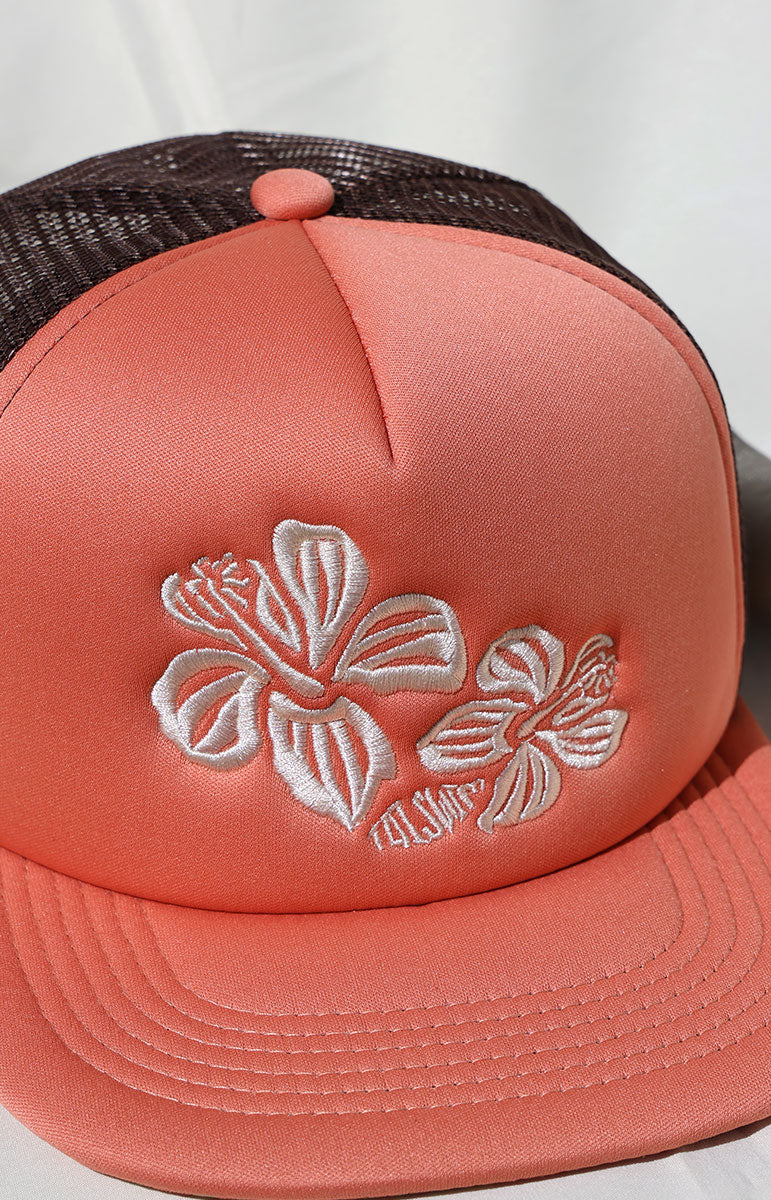 tai swim co logo pink embroidered adjustable foam pink trucker hat in unreleased hana print with hidden hibiscus print detail comfy trucker hat guava pink pastel colored hat from kailua oahu hawaii