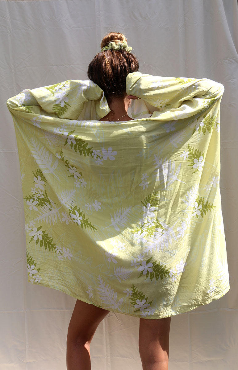 tai swim co coco sarong in hilo floral green yellow bikini print in comfy organic cotton recycled swimwear material cozy beach blanket moisture wicking hydrophobic recycled material pareo recycled fabric bikini accessories