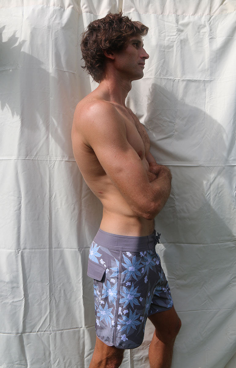 tai swim co austin boardshorts in matching kuahiwi and kahakai print designer 4 way recycled stretch boardshorts and trunks from hawaii kailua oahu sustainable swimwear brands from oahu matching bikini surf trunks made for surfing and kayaking in hawaii blue and purple naupaka flower 6 inch boardshorts for men with velcro pocket and good for surfing short 6 inch boardies