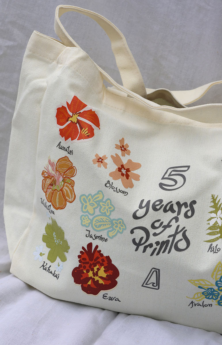 Cute and practical cotton tote bag from Tai Swim Co. with floral prints including Hilo, Avalon, Ka’ohao, Pua, Opihi, Hanalei, Blossom, Waikoloa, Ha’ena, Ewa, and Kahakai. Features long straps and the new Tai Swim logo, ideal for beach trips or grocery shopping