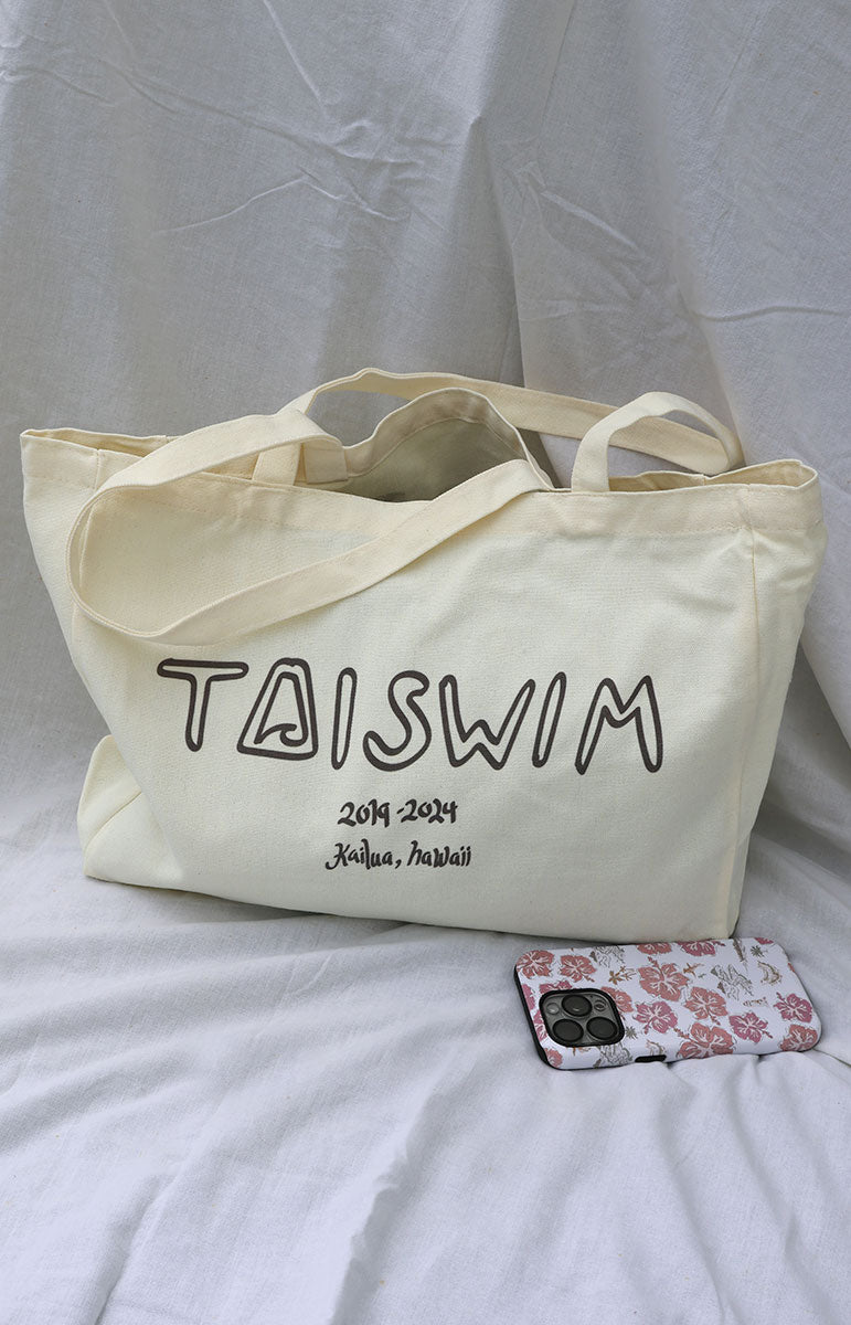 Tai Swim Co. floral print tote bag with long straps and separate designs like Hilo, Avalon, Ka’ohao, Pua, Opihi, Hanalei, Blossom, Waikoloa, Ha’ena, Ewa, and Kahakai. Includes the new Tai Swim logo on the back, perfect for the beach or as a stylish grocery bag local bikini brand oahu hawaii kailua handmade in hawaii