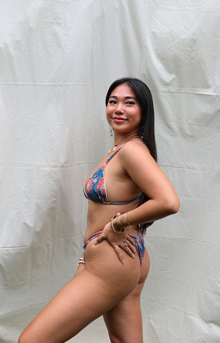 tai swim co joelle triangle top in kahala blue vintage floral blue green grey and white flower prints from oahu kailua hawaii windward side handmade sustainable swimsuits with recycled fabric kahala hawaii model from oahu hawaii cheeky two strap adjustable swimwear top