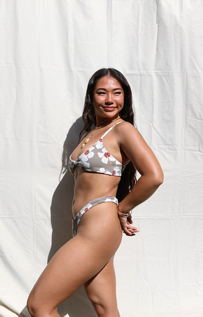 tai swim co kammi top in kailua ribbed textured swimwear floral white hibiscus flower print on a sustainable tan colored brown bikini in the sun on a girl in full sunlight photography open air outside e-commerce photos for swimwear sustainable Kailua Hawaii brand made in Hawaii Kailua tai swim cheeky minimal bikini sets