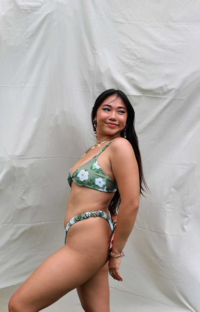 tai swim co kammi top in pikake green floral hawaiian flower inspired flower gardenia pattern with orange centers and white flowers twist tank top bikini style from kailua oahu hawaii scrunchy trendy bikinis