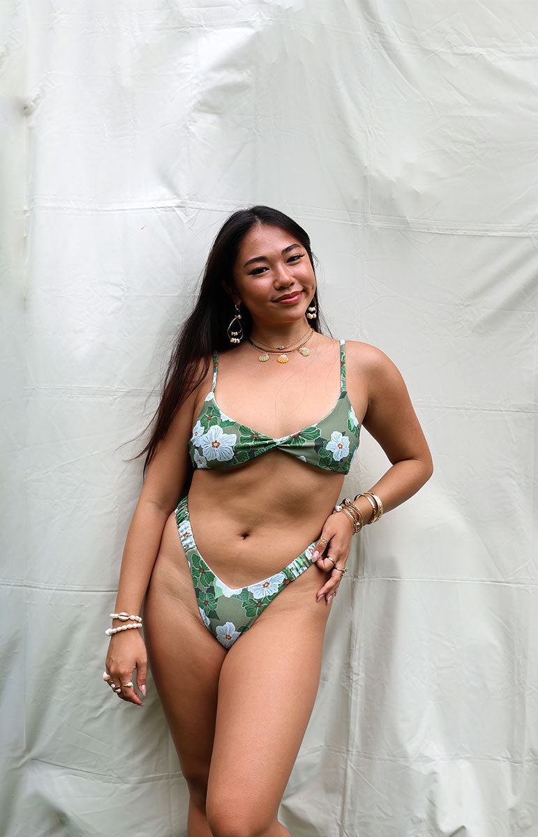 tai swim co kammi top in pikake green floral hawaiian flower inspired flower gardenia pattern with orange centers and white flowers twist tank top bikini style