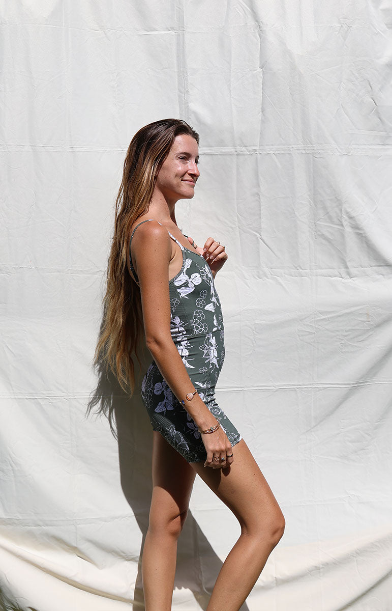 tai swim co kimi romper in pua green puakenikeni print with white ginger florals hand drawn on a green background activewear for yoga and pilates from oahu kailua hawaii