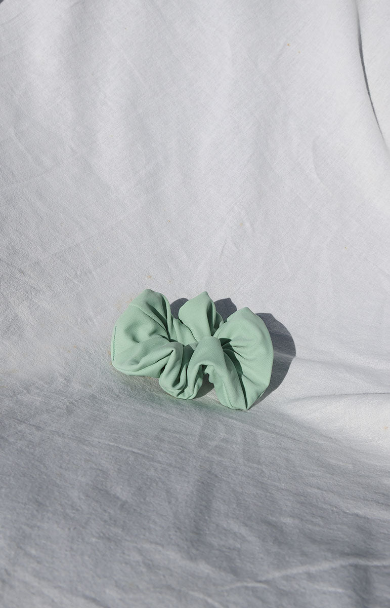 close up bright sustainable swimwear green foam smooth waterproof scrunchie ethically made eco friendly scrap material ponytail holder from hawaii