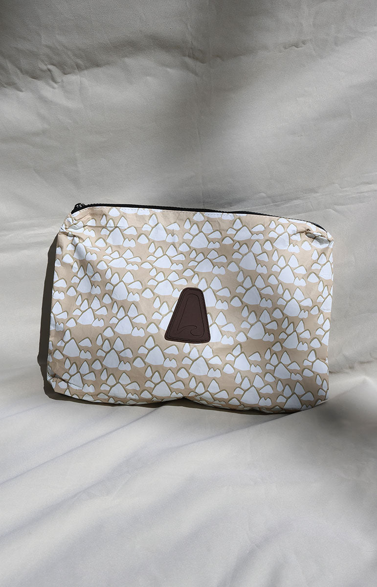 Cosmetic conus floral textile conus shell bag with geometric pattern on a white background