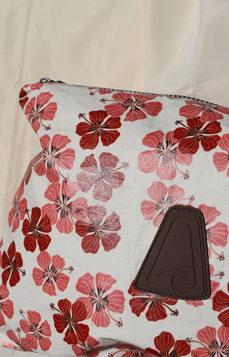 Floral-patterned tai swim co haleiwa pouch with a brown patch on a white background