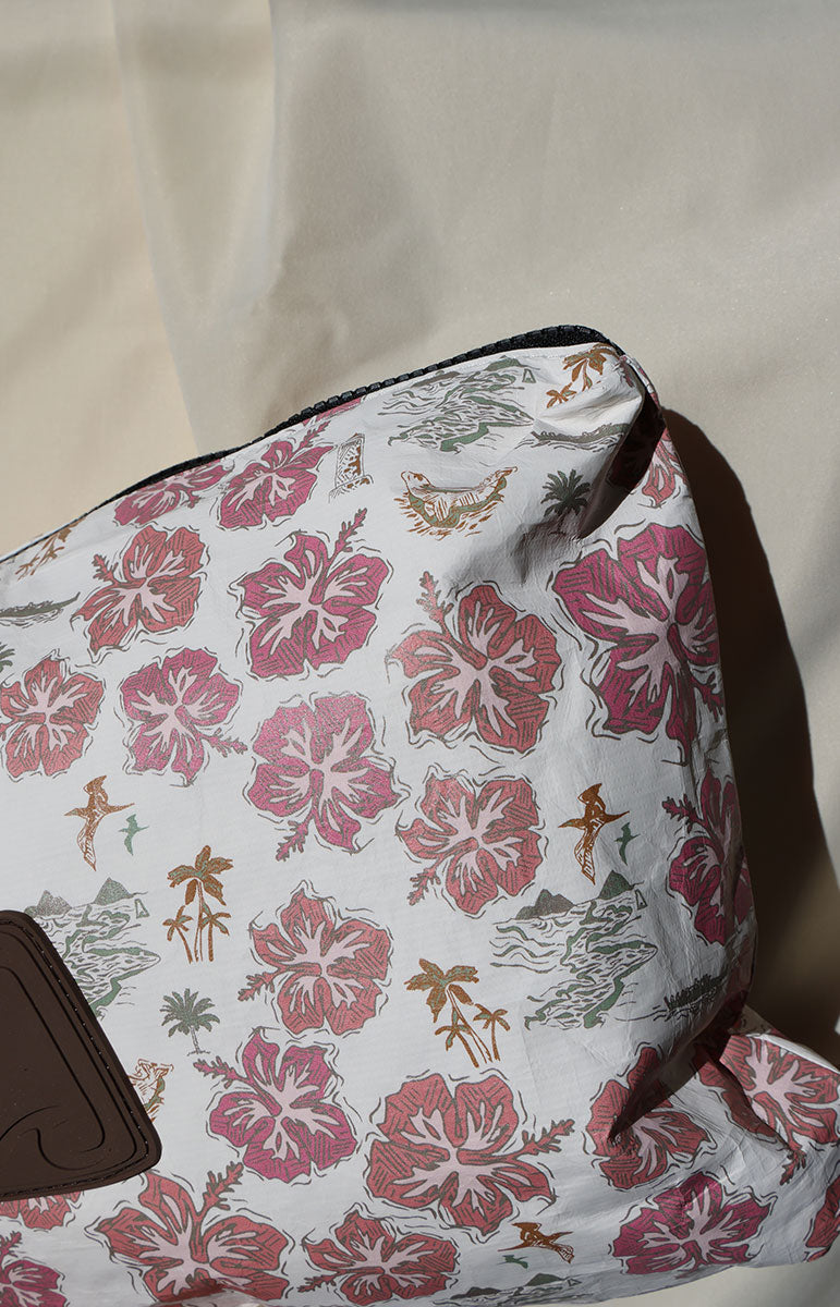 Floral patterned tai swim kaohao mini bag with pink flowers and brown accents on a beige background