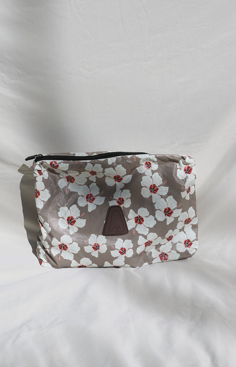 kailua tai swim co Floral-patterned pouch on a light gray background