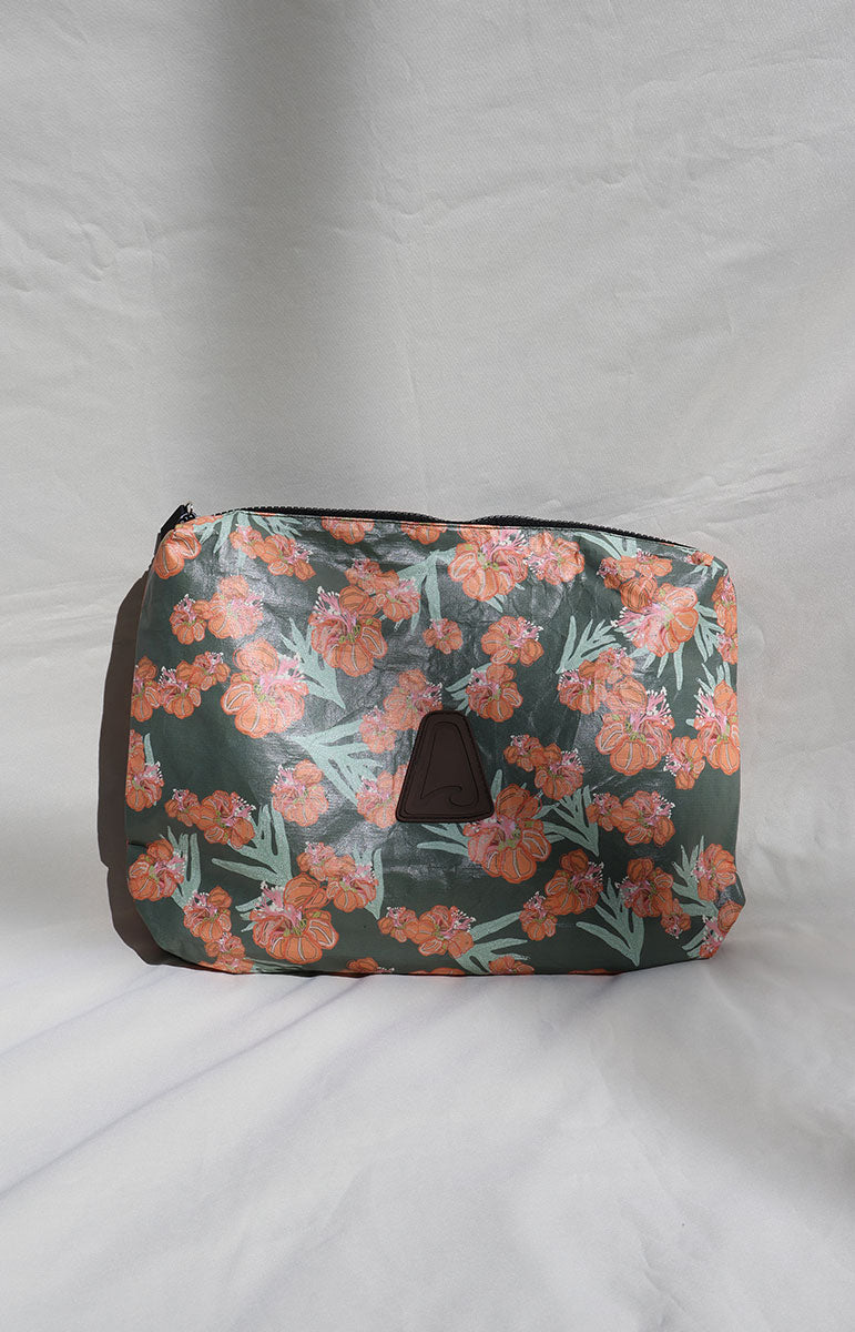 Waikoloa tai swim Floral-patterned zipper pouch on a gray background