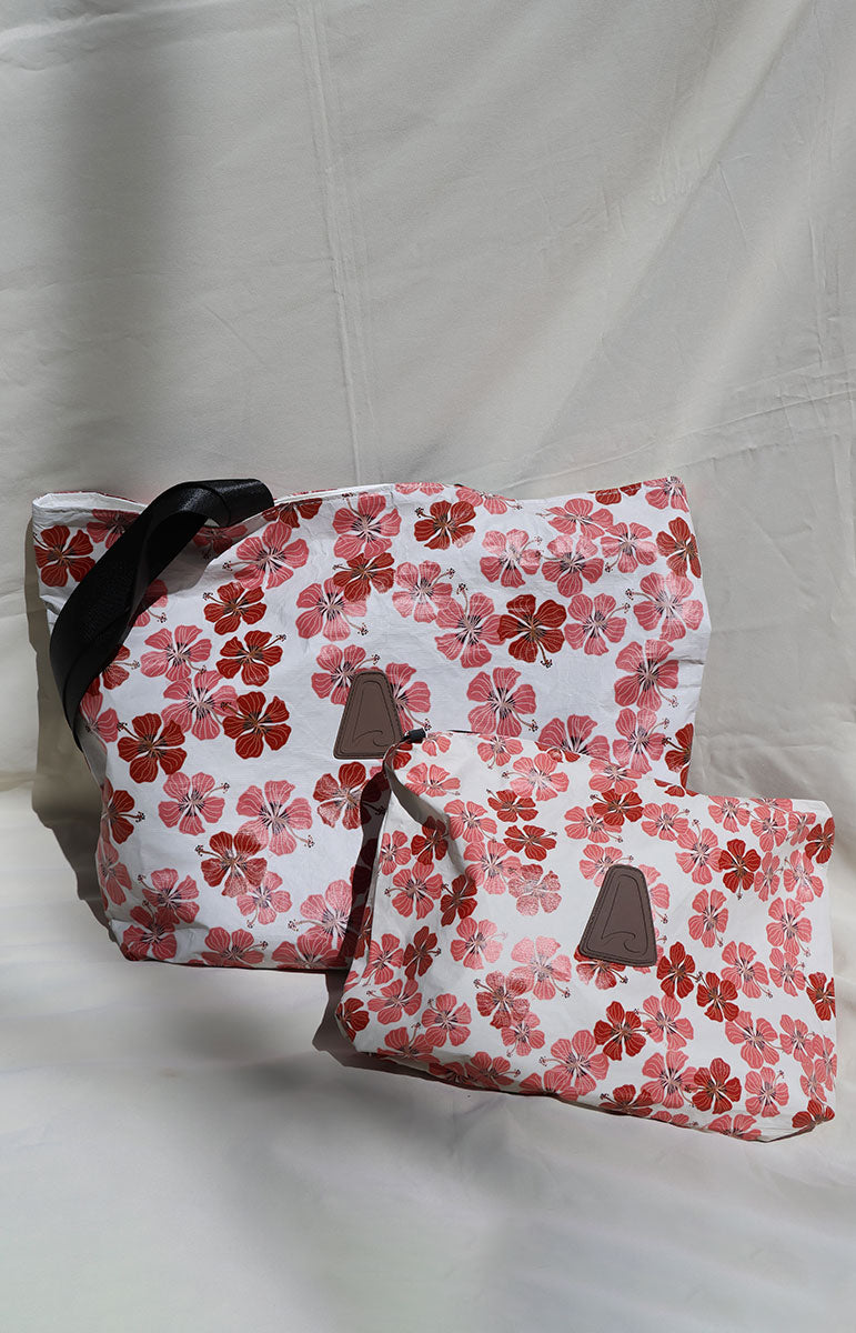Tai Swim co haleiwa red pink maroon floral hibiscus scattered busy pattern on a recycled tyvek bag from kailua oahu hawaii