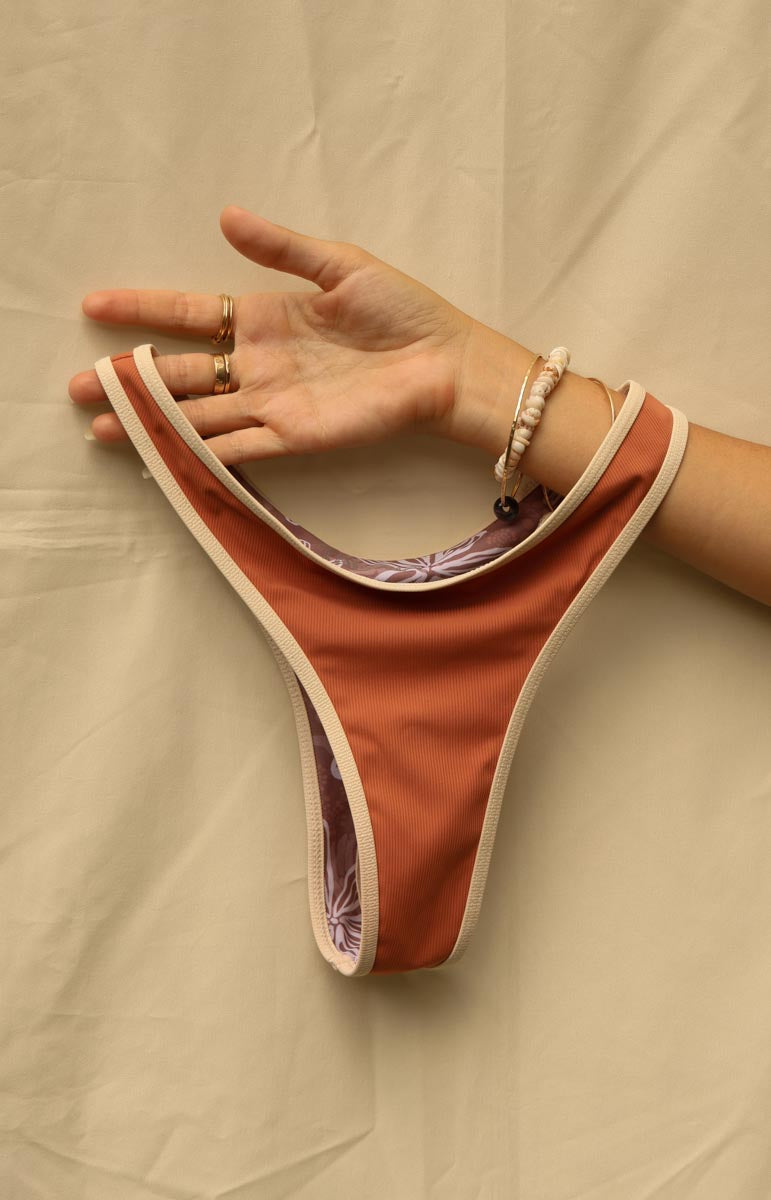 tai swim quinn bottom in canyon with contrasted piping border sustainable swimwear