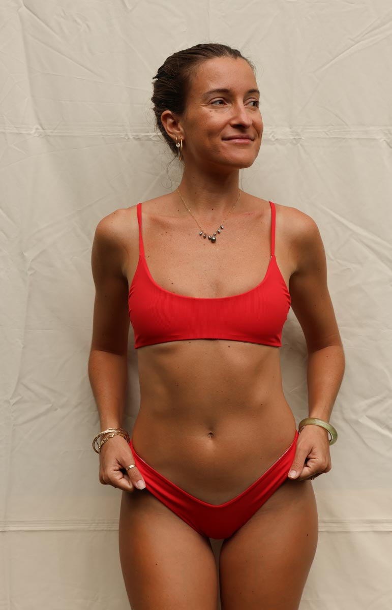 tai swim co red lehua sailor thong v cut bottom on plain white curtain