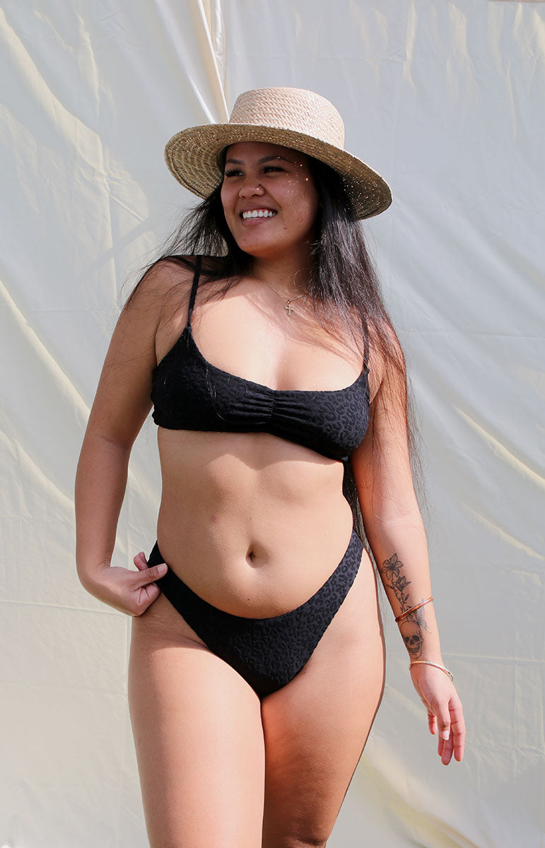 tai swim co emma bottom in hiwahiwa black animal print bikini bottoms with sporty ruching on the back sustainable swimsuits from hawaii