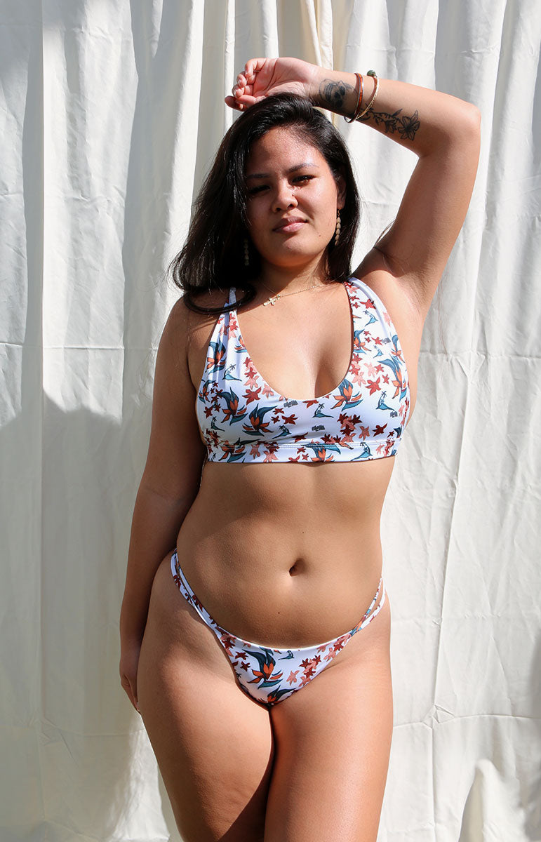 https://taiswim.co/cdn/shop/products/tai-swim-co-karson-top-in-leahi-tropical-vintage-aloha-print-white-and-red-orange-printed-floral-strappy-bikini-sets-sport-bra-top.jpg?v=1705268513&width=771