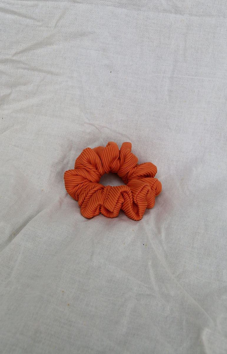 tai swim co matching sustainable scrunchie and ponytail holder made form recycled swimwear materials in hawaii terracotta orange scrunchie print 